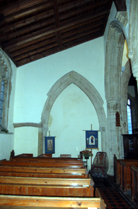 The blocked arch to the ruined north chancel chapel January 2010